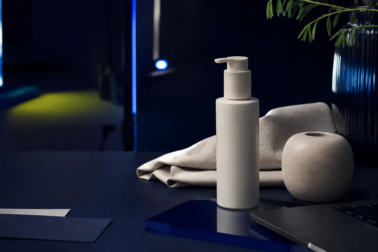 Unbranded skincare product and design materials in a dark creative studio